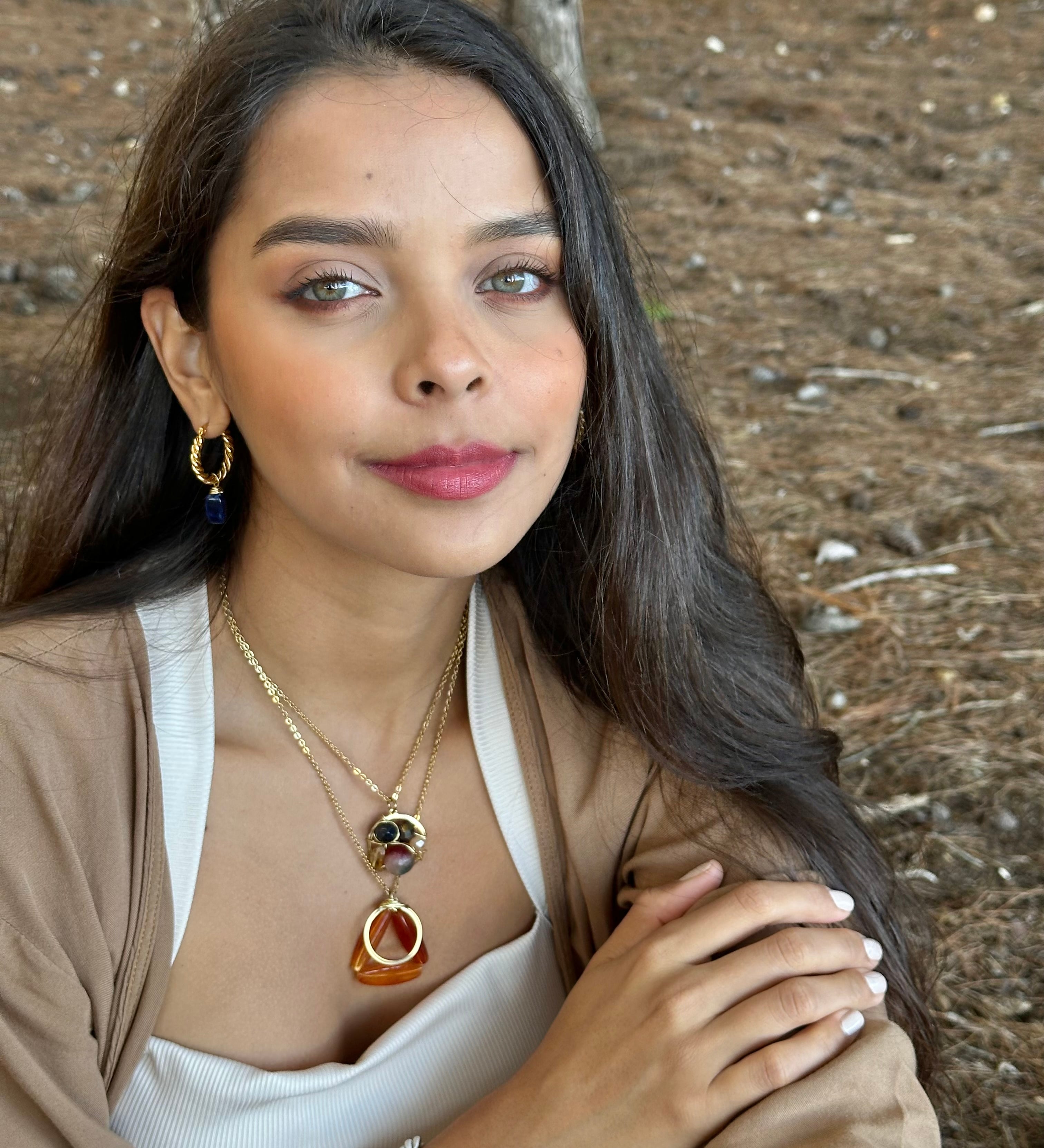 Woman with jewelry in a forest setting